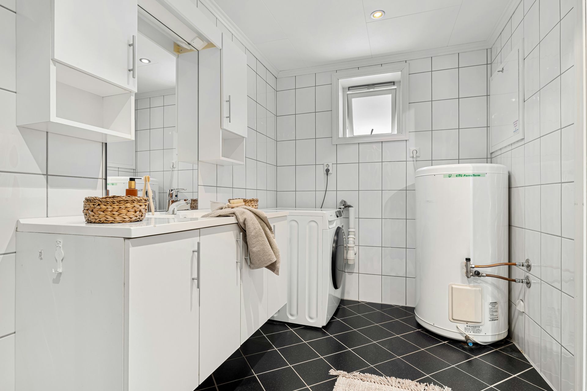 A bathroom with a washer and dryer in it